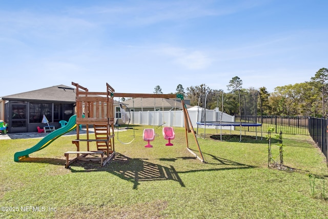 view of play area with a sunroom, a trampoline, a fenced backyard, and a lawn