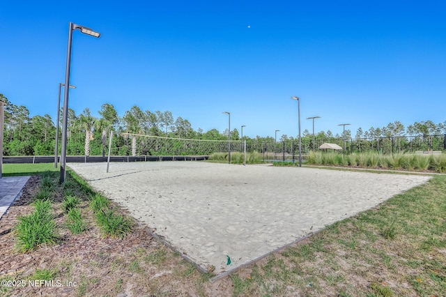 view of property's community featuring fence and volleyball court