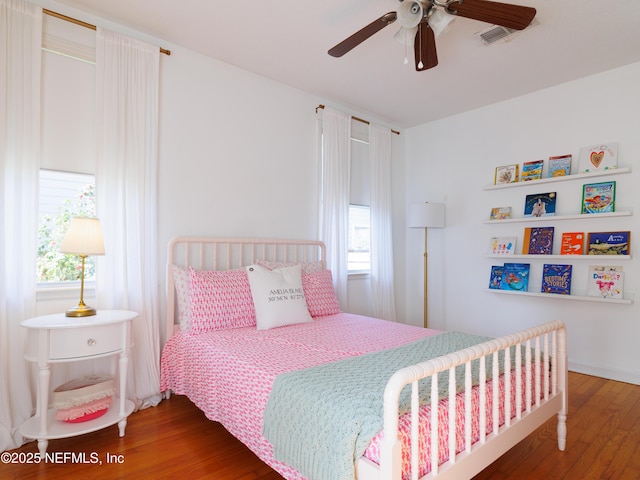 bedroom with ceiling fan and wood finished floors