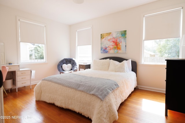 bedroom with baseboards and light wood-style floors