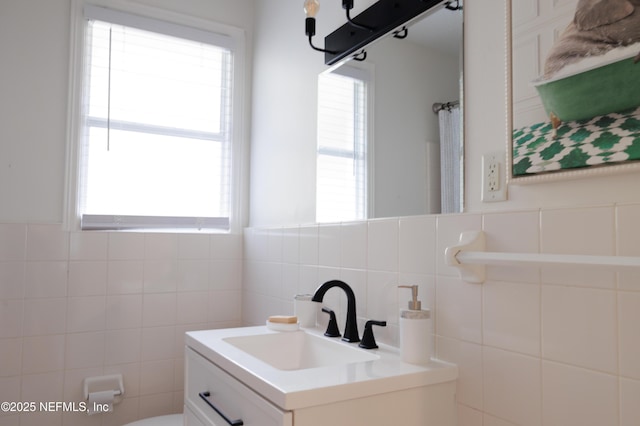 bathroom featuring toilet, a shower with shower curtain, tile walls, and vanity