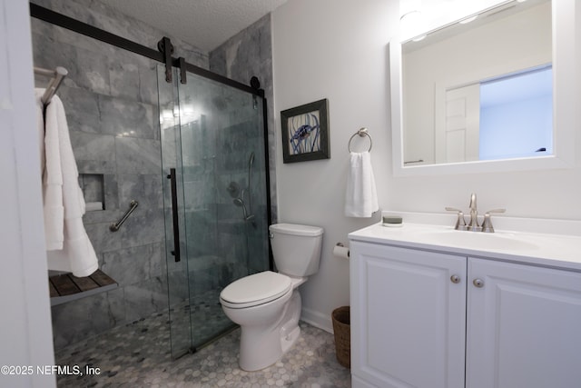 bathroom with a textured ceiling, vanity, a shower stall, and toilet