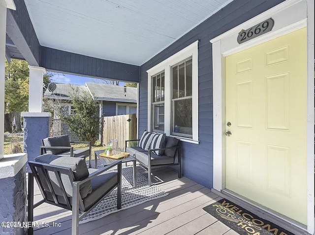 exterior space featuring covered porch and outdoor lounge area