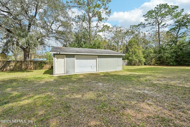 exterior space with an outbuilding and fence