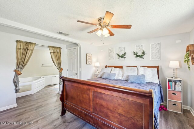 bedroom with visible vents, ceiling fan, a textured ceiling, and wood finished floors