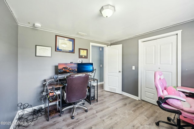 office space with baseboards and wood finished floors