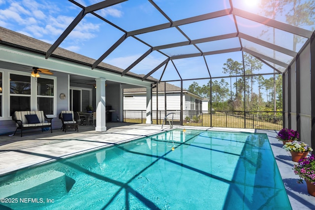 view of swimming pool featuring a fenced in pool, glass enclosure, a patio, and a ceiling fan