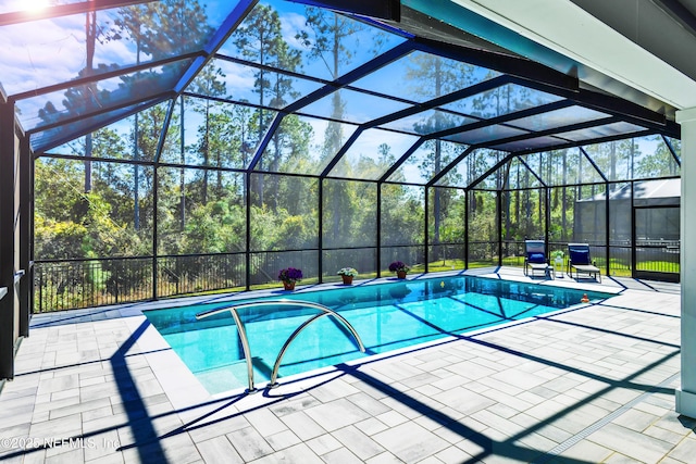 outdoor pool with a lanai and a patio