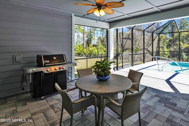 sunroom / solarium with a ceiling fan