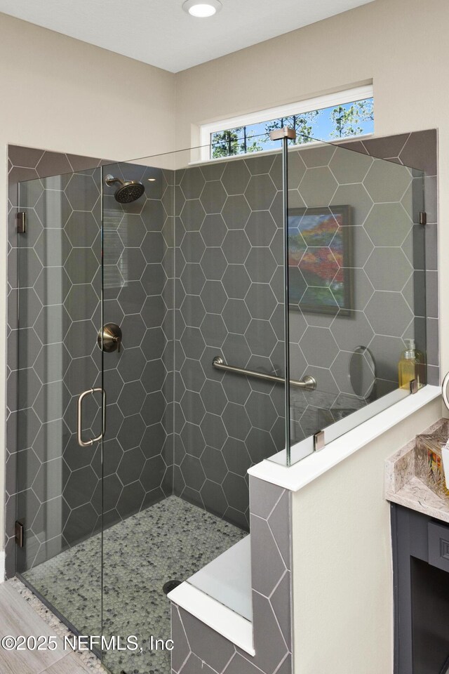 bathroom with a walk in shower and vanity