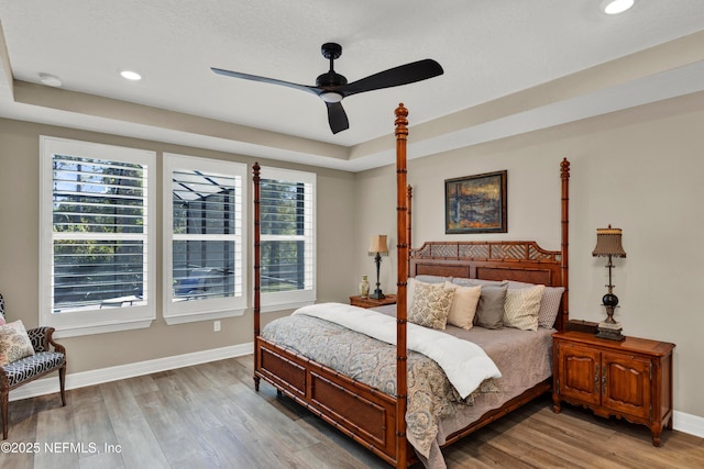 bedroom with light wood-style floors, recessed lighting, and baseboards