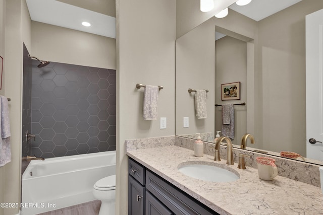 full bathroom featuring toilet,  shower combination, and vanity