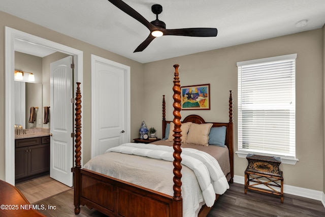 bedroom featuring light wood-style floors, ceiling fan, baseboards, and connected bathroom