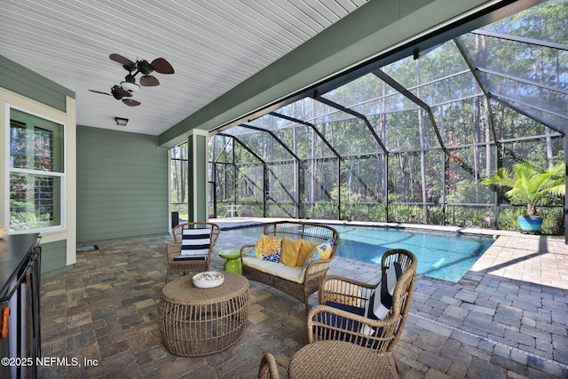 view of patio / terrace featuring outdoor lounge area, a lanai, an outdoor pool, and ceiling fan
