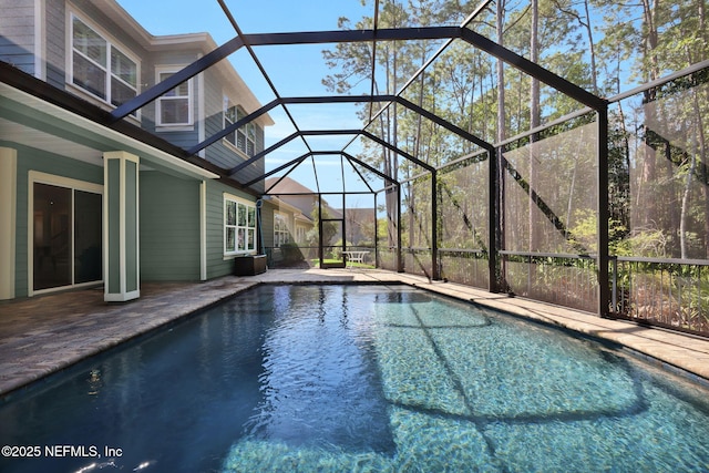 outdoor pool featuring a lanai and a patio area