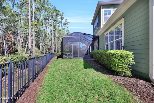 view of yard with a lanai and a fenced backyard