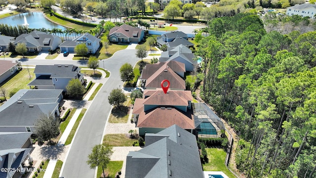 bird's eye view featuring a residential view and a water view