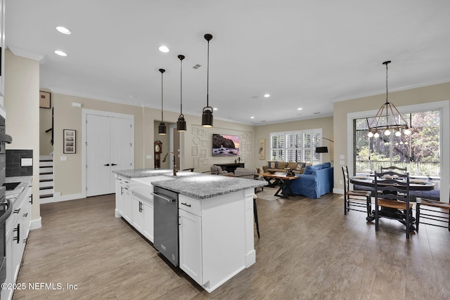 kitchen with a notable chandelier, light wood-style floors, and ornamental molding