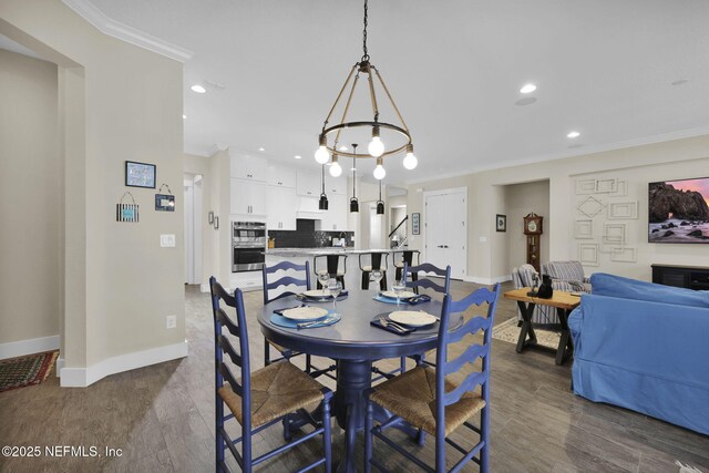 dining room featuring baseboards, dark wood-style flooring, and ornamental molding