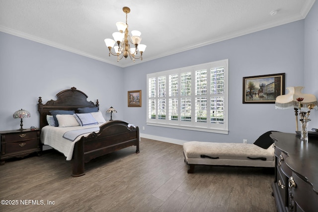 bedroom with crown molding, a notable chandelier, wood finished floors, and baseboards
