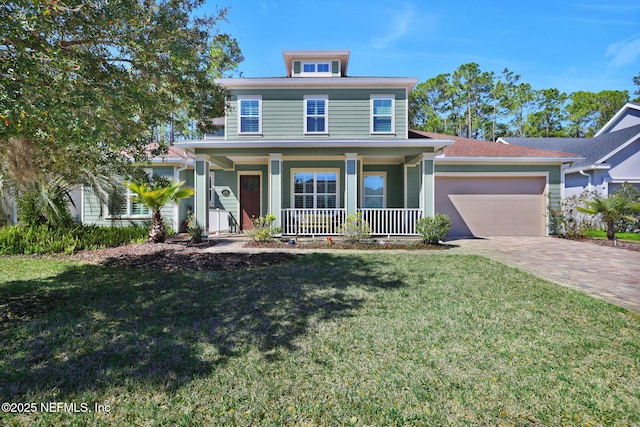 traditional style home featuring a front lawn, an attached garage, a porch, and driveway