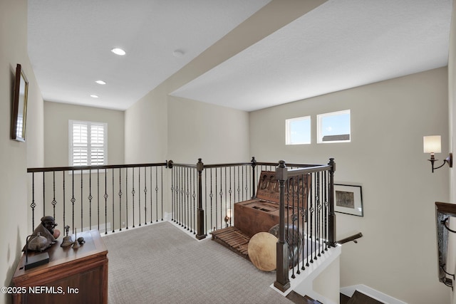 corridor featuring recessed lighting, an upstairs landing, and carpet floors