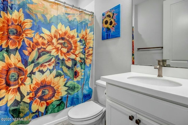 full bath featuring toilet, a shower with shower curtain, and vanity