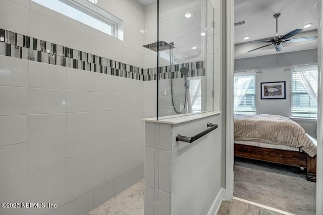 full bathroom with a walk in shower, connected bathroom, a wealth of natural light, and a ceiling fan