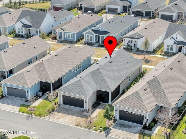 birds eye view of property with a residential view