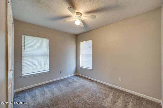 unfurnished room featuring carpet, baseboards, ceiling fan, and a textured ceiling