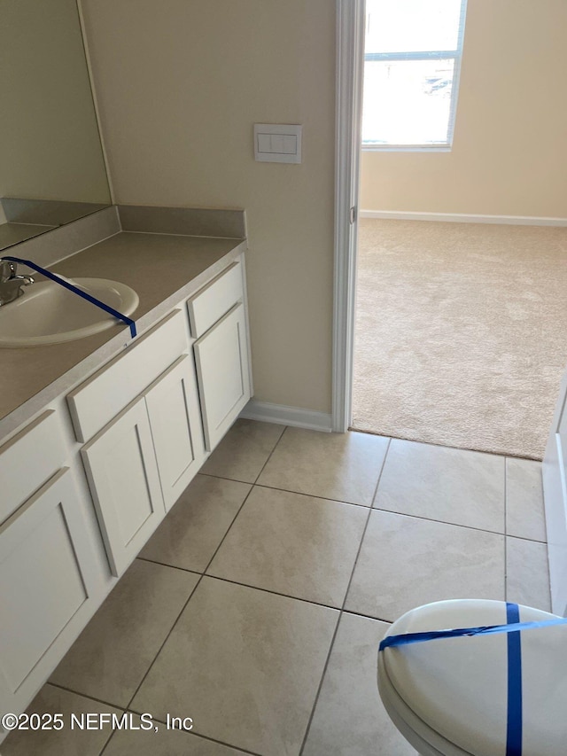 bathroom featuring vanity, baseboards, and tile patterned floors