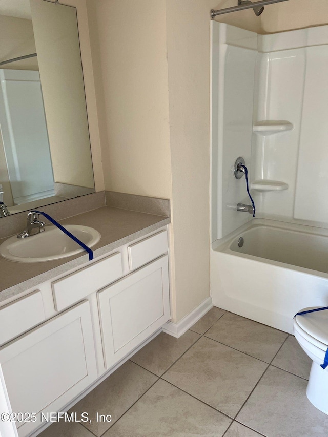 full bathroom with bathing tub / shower combination, toilet, vanity, tile patterned flooring, and baseboards