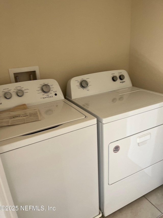 washroom featuring laundry area, washer and clothes dryer, and tile patterned floors