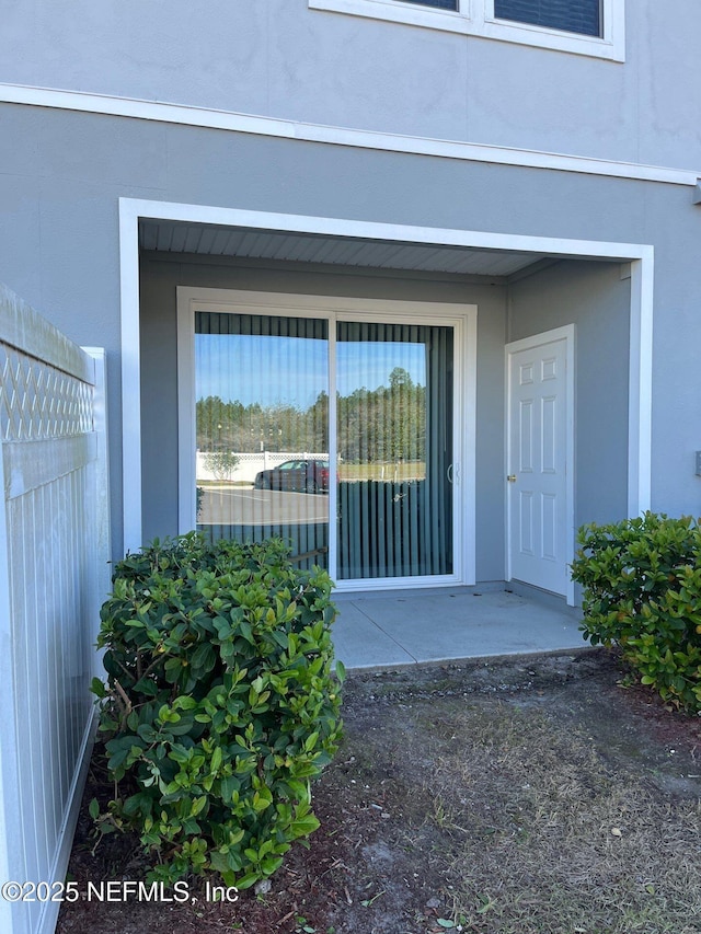 entrance to property with stucco siding