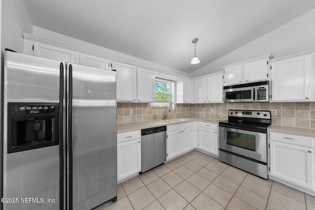 kitchen with tasteful backsplash, appliances with stainless steel finishes, light countertops, and a sink