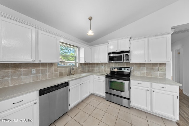 kitchen featuring white cabinets, stainless steel appliances, and a sink