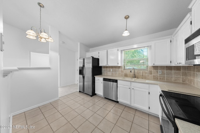 kitchen with backsplash, stainless steel appliances, a sink, and light countertops