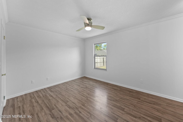 unfurnished room featuring ornamental molding, ceiling fan, a textured ceiling, wood finished floors, and baseboards