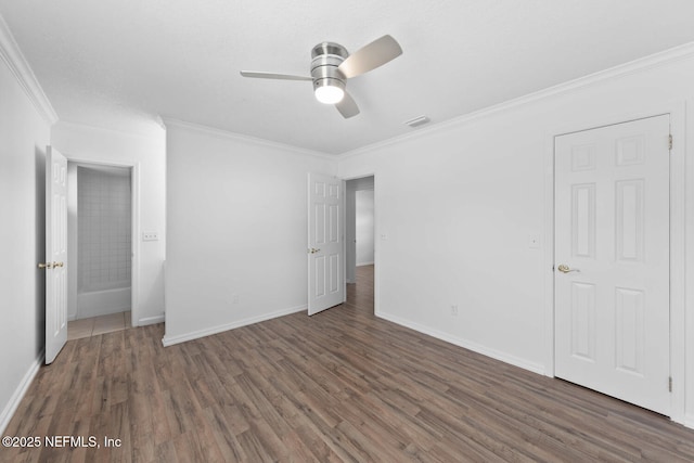 unfurnished bedroom with baseboards, visible vents, a ceiling fan, ornamental molding, and wood finished floors