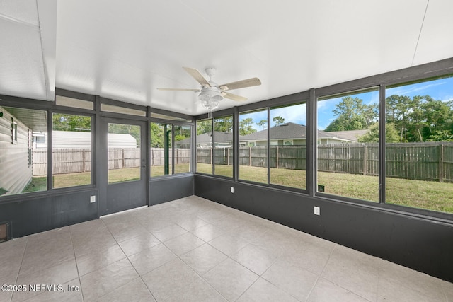 unfurnished sunroom featuring ceiling fan