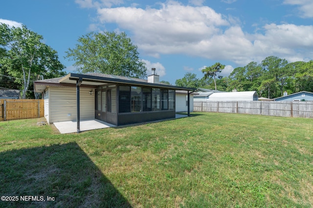 view of yard with a patio, a fenced backyard, and a sunroom