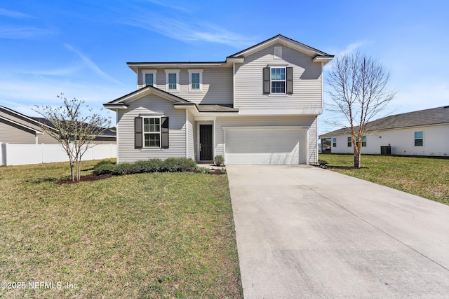 traditional-style house featuring a garage, driveway, a front yard, and fence