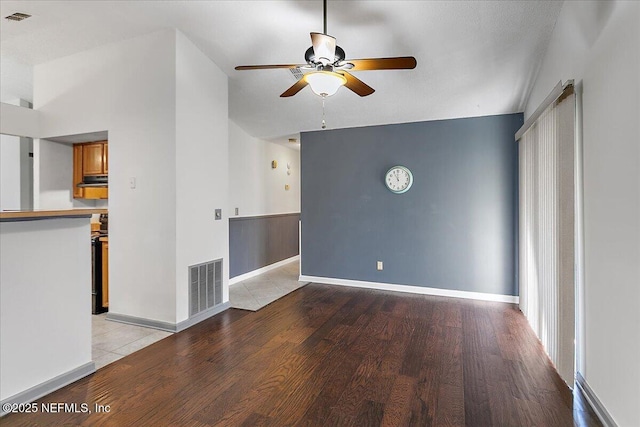 spare room featuring baseboards, visible vents, and light wood finished floors