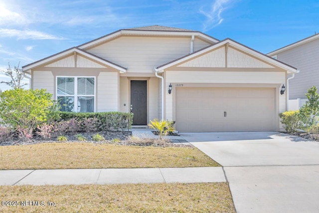 view of front of house with concrete driveway and an attached garage