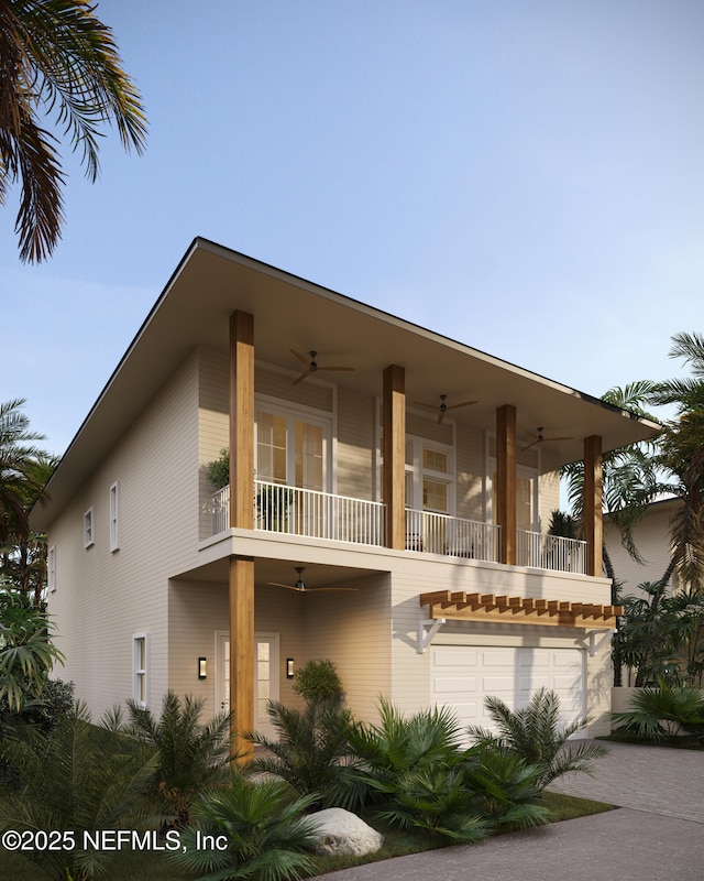 view of front facade with a ceiling fan, a balcony, and a garage