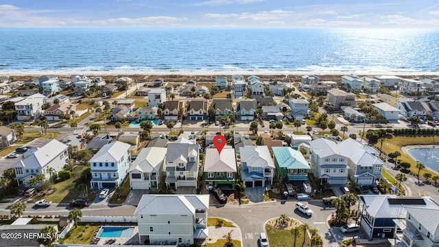 birds eye view of property with a residential view, a water view, and a beach view