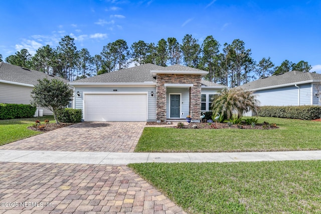 view of front of property featuring a garage, stone siding, a front lawn, and decorative driveway