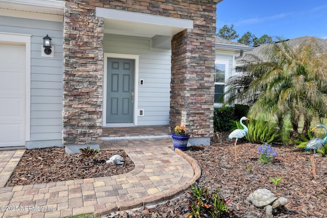 property entrance featuring stone siding