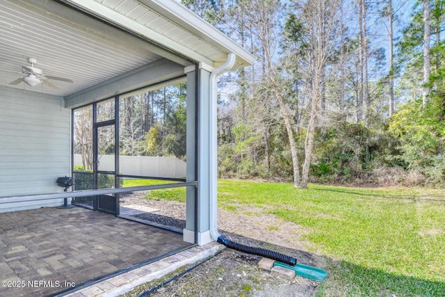 unfurnished sunroom with a ceiling fan