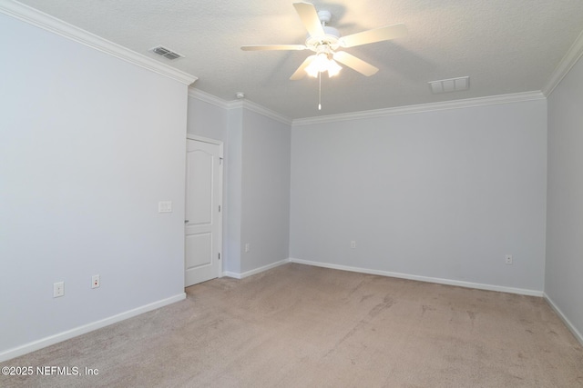 carpeted spare room with ceiling fan, a textured ceiling, visible vents, and crown molding